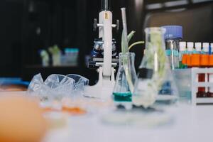 A laboratory table with a microscope, vials and other items photo