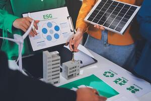 People working on a project with a green energy sign photo