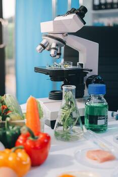 A microscope and vegetables on a table photo