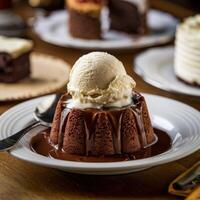 Decadent dessert featuring a moist chocolate cake topped with a scoop of vanilla ice cream. photo