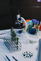 A table with a microscope, a microscope, and other items photo