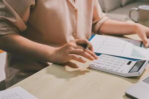 A woman is using a calculator to do some calculations photo