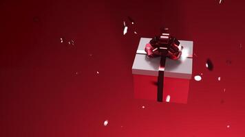 A gift with a red bow is spinning on a red background with falling confetti video