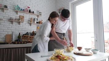 happy couple having wonderful time while cooking apple pie and hugging in a cheerful atmosphere together. Kitchen, housework video