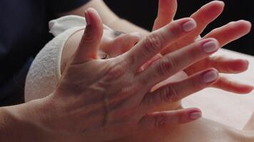 Beautiful woman enjoying facial massage with closed eyes at spa salon video