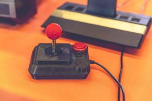 Retro Gaming Joystick and Classic 80s Console Close-Up photo
