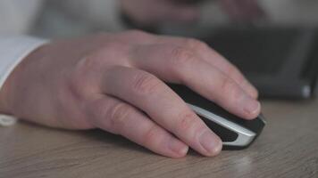 A hand firmly gripping a sleek computer mouse while focusing intently on maximizing productivity and technology video