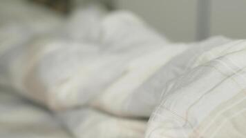 A closeup of a soft, cozy white blanket on a neatly made bed, creating a relaxing and inviting atmosphere video