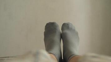 A cozy and inviting scene showcasing feet clad in soft grey socks, ideal for conveying deep relaxation and comfort video