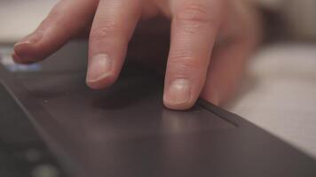 A close-up view of a hand interacting with a laptop touchpad, capturing modern technology in action. video