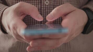 close hands typing a message on a smartphone video