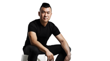 A man in a black outfit sitting confidently on a stool against a dark background ideal for fas png