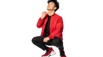 A person in a vibrant red jacket and matching sneakers striking a dynamic pose against a black png