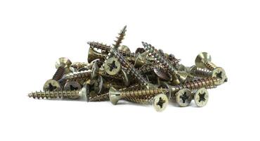 Heap of self-tapping screws sits on white, commonly used in various construction and woodworking photo