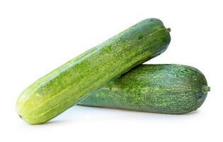 Side view of two long green cucumbers in stack and cross shape in horizon isolated on white background with clipping path photo
