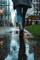 A person walking in the rain on a city street photo