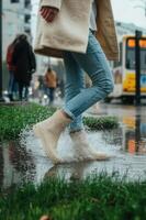 A woman in white boots is walking in the rain photo