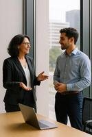 Two business people talking in an office photo