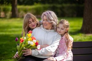 Three generations family with tulip bouquet photo