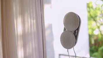 Window cleaning robot with visible rotating brushes on glass. photo
