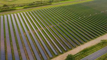 Aerial view of solar panels with railway tracks in background photo