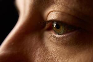 Close-up of female eye with iris and eyelashes photo