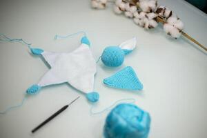 knitted toy bunny in the process of making with your own hands photo