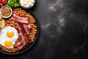 English breakfast on a plate with scrambled eggs, sausages, bacon, beans, toast and coffee on a dark stone background. photo
