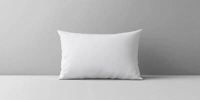 Simple white pillow on a clean grey surface in a modern interior setting photo