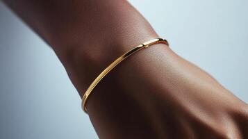 Elegant gold bracelet adorned on a woman's wrist in soft lighting photo