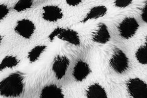 Soft and cozy fabric featuring black and white polka dots ideal for various textile projects photo