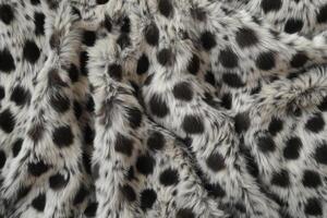 Soft and stylish faux fur fabric with black and white spots for cozy home decor photo