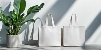 Stylish white reusable bags next to a green plant on a minimalist surface in bright natural light photo