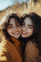Two friends enjoy a joyful moment outdoors in golden fields during a sunny afternoon photo