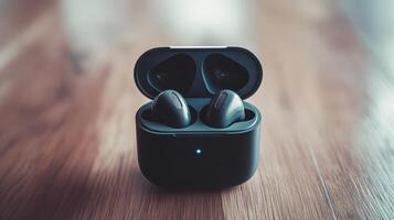 Wireless earbuds charging in a sleek case on a wooden surface, reflecting modern design and technology photo
