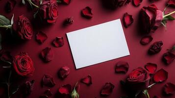 Beautiful red roses surround a blank card on a deep red background, perfect for a romantic message or greeting photo