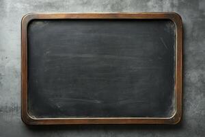 Empty black chalkboard framed in wood, ready for notes and drawings in an educational setting photo