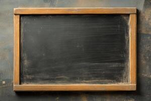 Empty blackboard with wooden frame ready for new lessons in a classroom setting photo