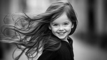 Joyful girl with flowing hair smiling in a city setting during a sunny day photo