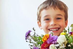 Happy boy smiling while holding a colorful bouquet of flowers against a light background photo