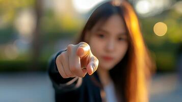 Woman pointing decisively in a park during the golden hour of evening light photo