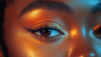 Captivating close-up of a beautifully made-up eye with shimmering golden tones and striking eyeliner photo