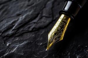 Luxurious black and gold fountain pen nib showcasing fine craftsmanship against a dark textured backdrop photo