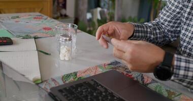 A man is using a laptop to type on a keyboard photo