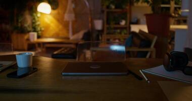 A laptop on a desk with a cup of coffee and a phone photo