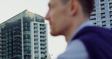 A man is standing in front of a building photo