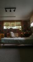 a bedroom interior with patterned wallpaper design and a bed in the middle photo