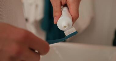 puting toothpaste on a toothbrush photo