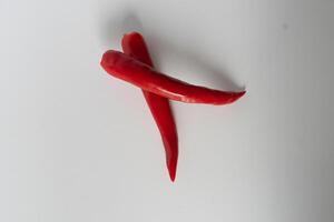 Overlapping vibrant red chili peppers isolated against a simple white background photo