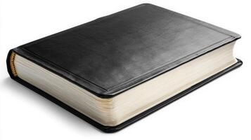Black leather-bound book resting on a smooth surface with visible textured cover and gold-edged pages photo